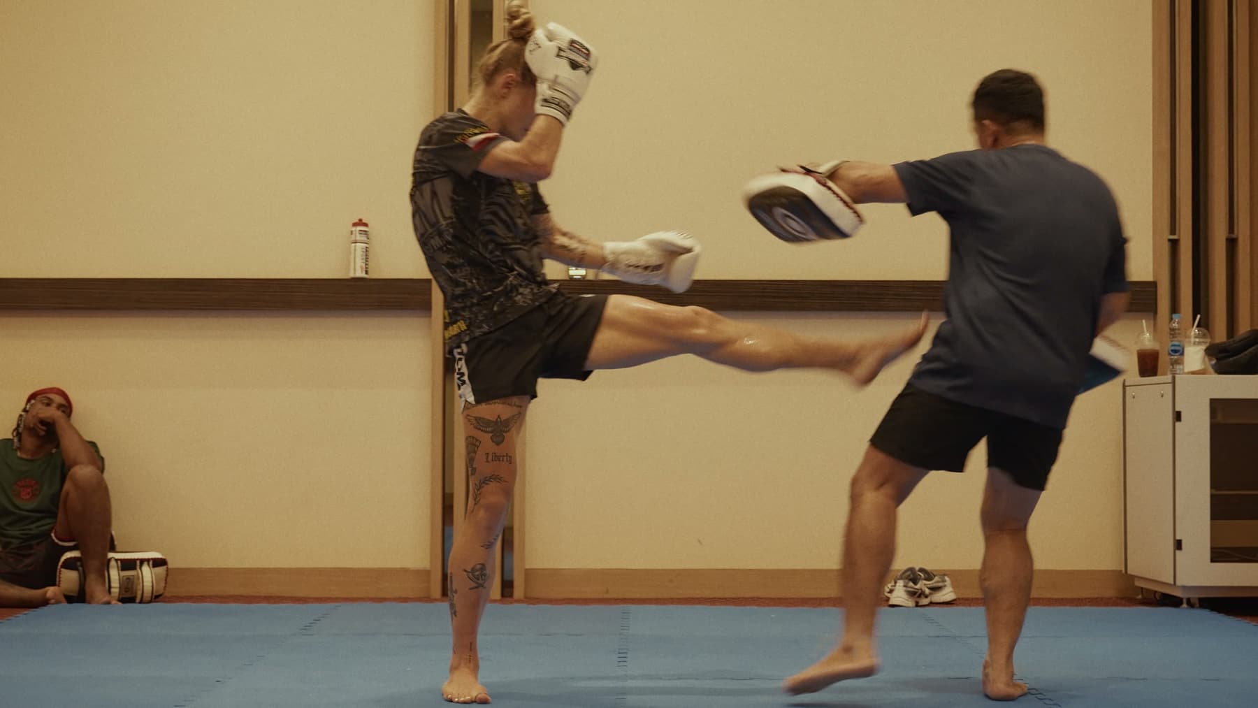 Stella kicking pads during training